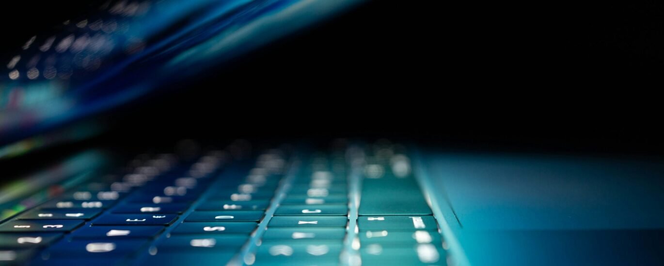 closeup photo of turned-on blue and white laptop computer