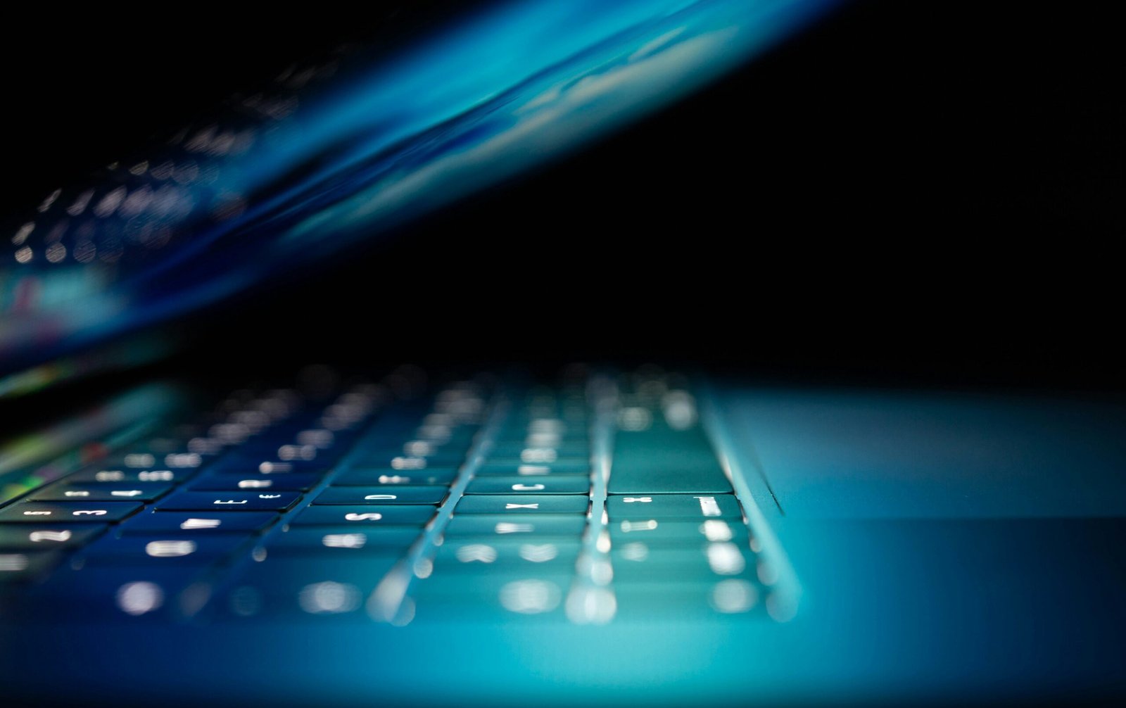 closeup photo of turned-on blue and white laptop computer